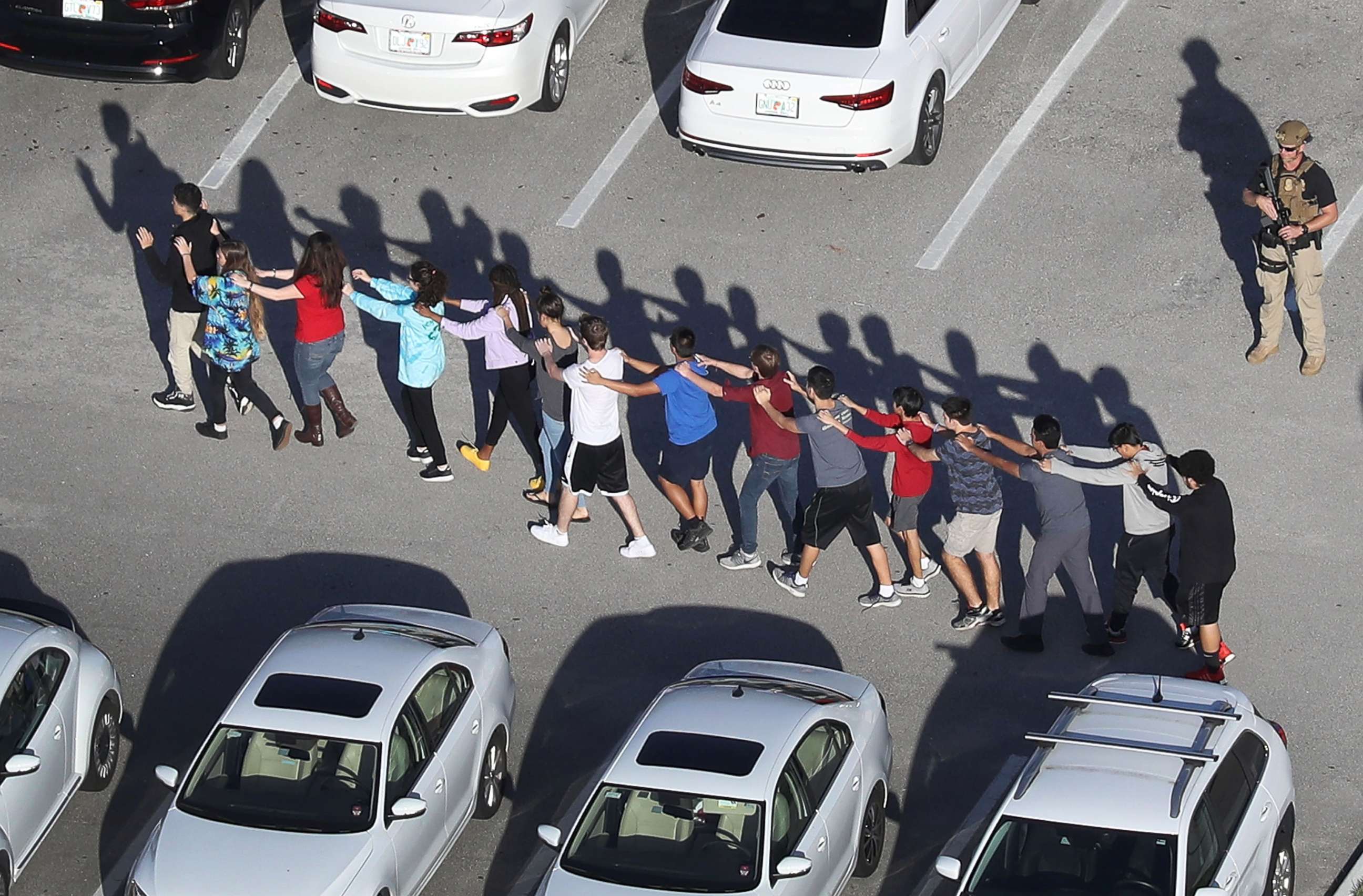 PHOTO: People are brought out of the Marjory Stoneman Douglas High School after a shooting at the school that killed and injured multiple people on Feb. 14, 2018, in Parkland, Fla.