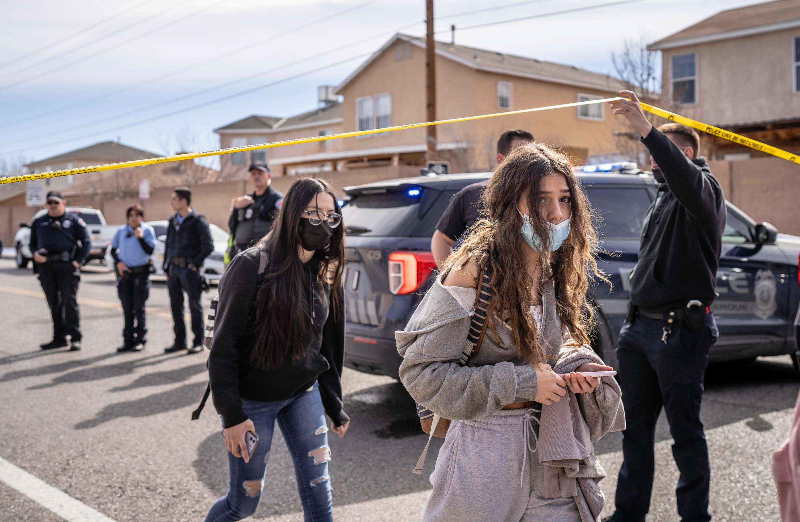 PHOTO: In this Feb. 25, 2022, file photo, students are released from school to go and join their parents in a nearby field after a student was killed in a shooting near West Mesa High School, in Albuquerque, N.M.
