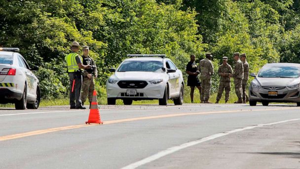 PHOTO: Military police and civilian first responders stand along Route 293 in response to a rollover of a truck in which at least one person was killed on Thursday, June 6, 2019, in Cornwall, N.Y.