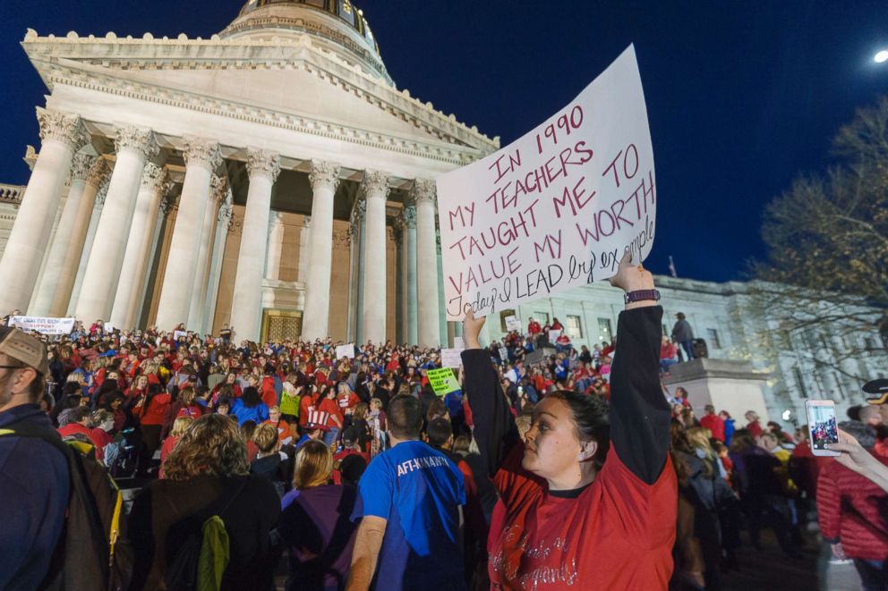 PHOTO: Jennyerin Steele Staats, a special education teacher holds her sign aloft outside of the capitol building on Feb. 27, 2018, in Charleston, W.Va. 
