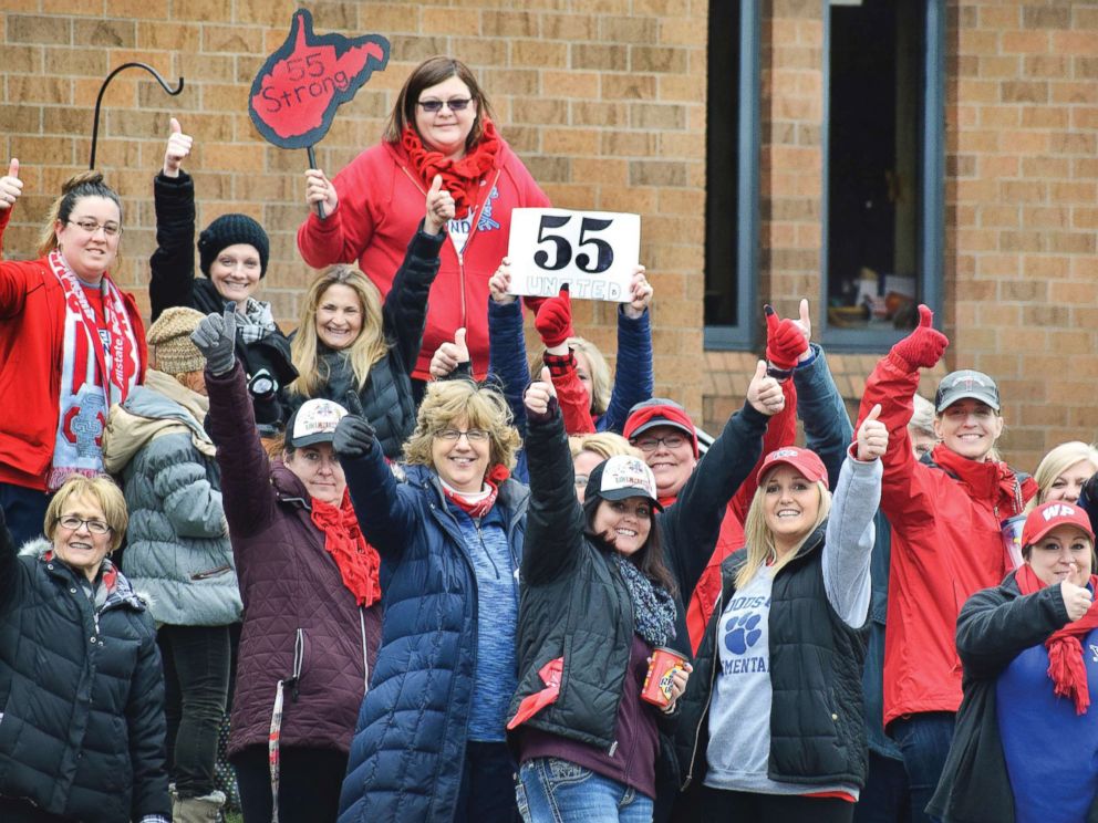 PHOTO: Teachers give a thumbs-up in front of Woodsdale Elementary in Wheeling, W. Va., on March 6, 2018, after teachers across the state received notice that a deal was reached to end the teacher walkout.