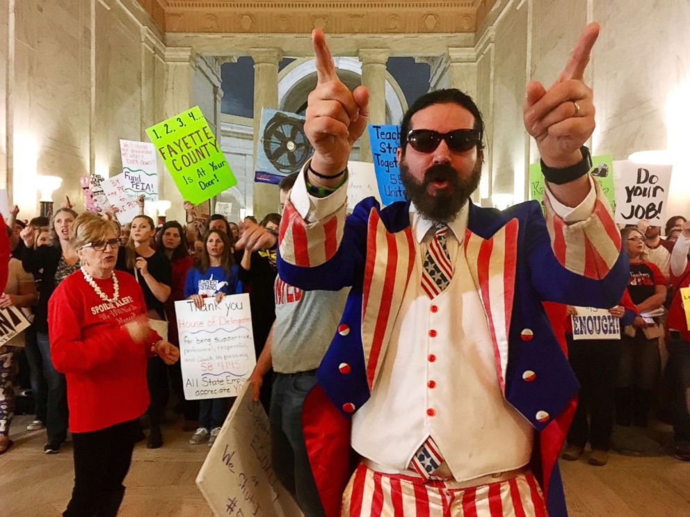PHOTO: Parry Casto, a fifth grade teacher at the Explorer Academy in Huntington, W.Va., dressed in an Uncle Sam costume leads hundreds of teachers in chants outside the state Senate chambers at the Capitol in Charleston, W.Va., March 1, 2018.