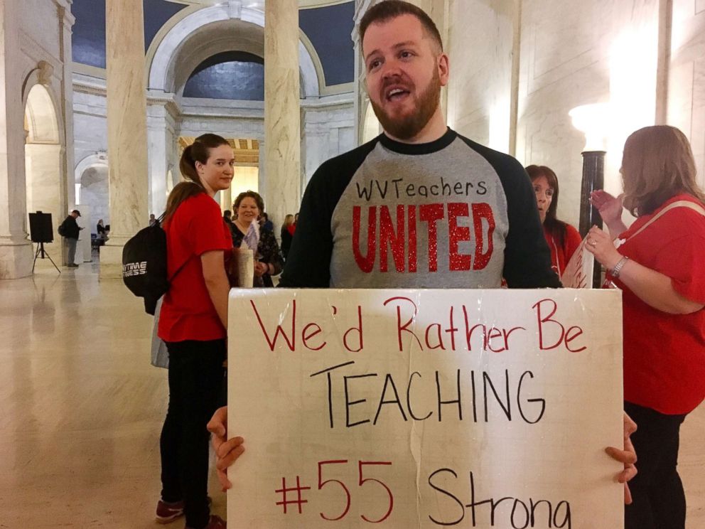 PHOTO: Jacob Staggers, a sixth-grade English teacher at South Middle School in Morgantown, W.Va., holds up a sign outside the state Senate chambers at the Capitol in Charleston, W.Va., March 1, 2018.