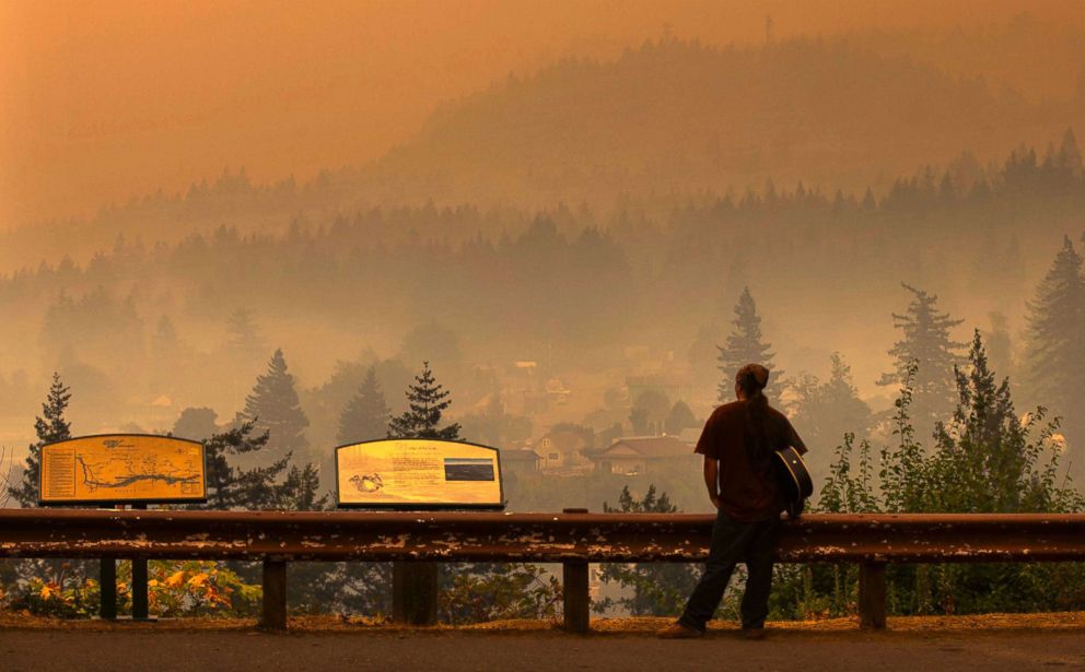 PHOTO: Jason Wheeler looks out across the Columbia River at the smoky community of Cascade Locks, Ore. on Sept. 5, 2017, after being evacuated from his home.