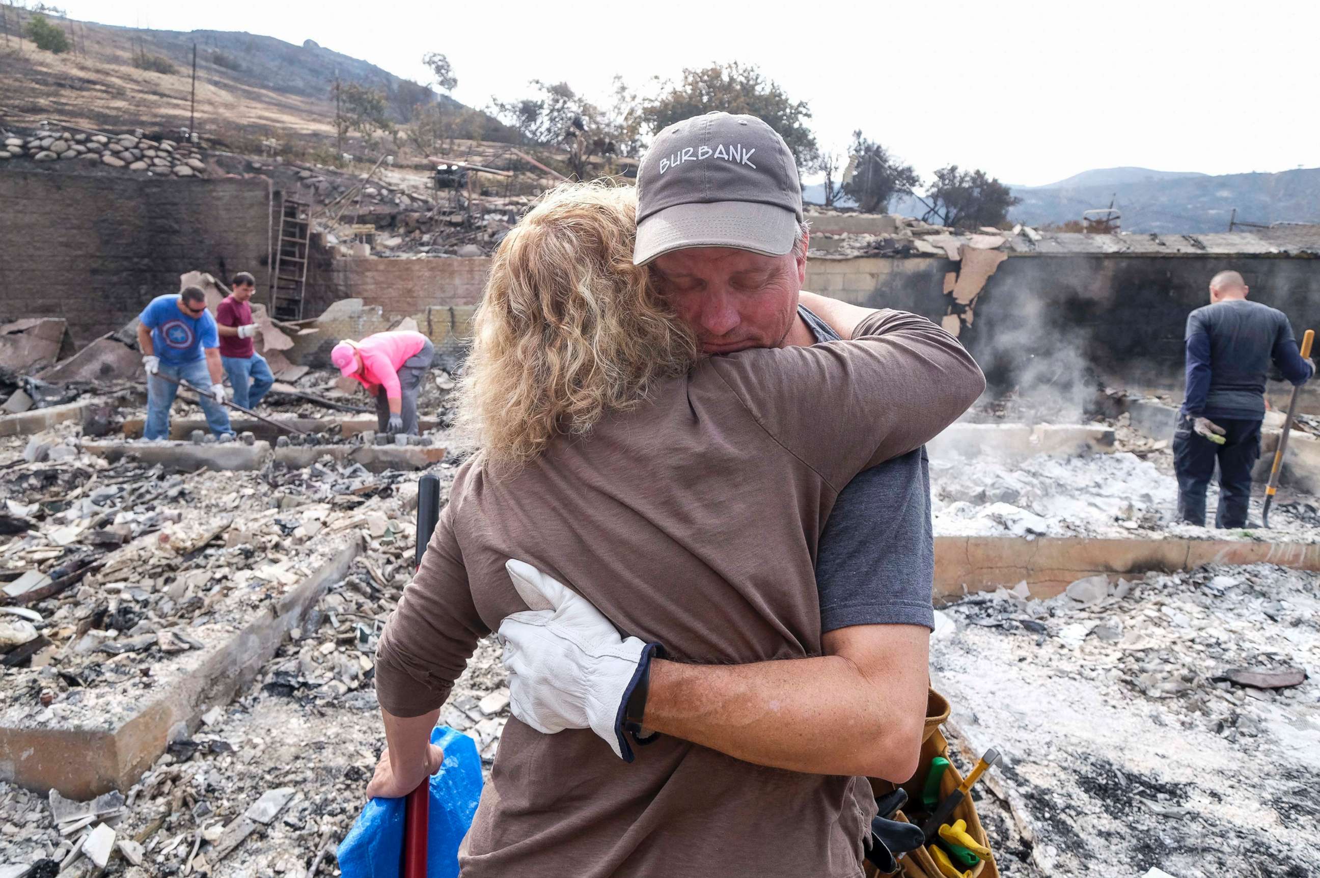 PHOTO: Craig Bolleson hugs his friend in his burned out home, Sept. 4, 2017, in the Sunland-Tujunga section of Los Angeles.  