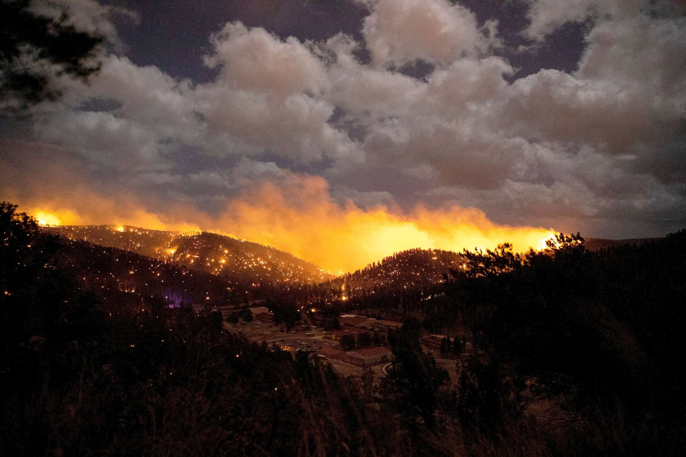 PHOTO: The McBride Fire burns in the heart of the village in Ruidoso, N.M., April 12, 2022.