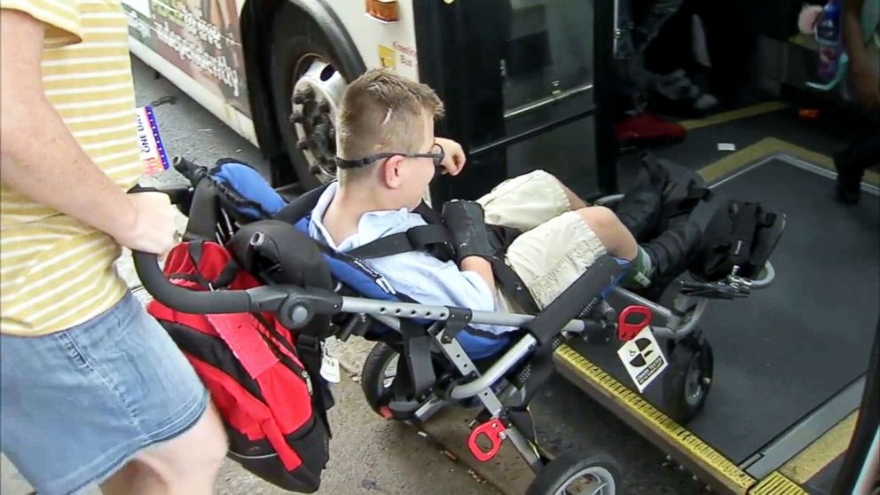 PHOTO: Ryan Lewis boards a bus with the help of his mother, Meghan Johnson, in this image made from video.