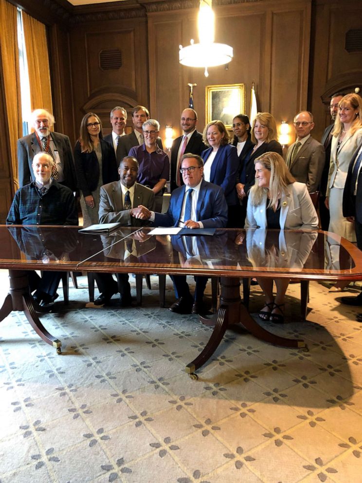 PHOTO: Environmental Protection Agency administrator Andrew Wheeler and Department of Housing and Urban Development Secretary Ben Carson sign a new rule on limiting lead in dust at EPA headquarters in Washington, DC.