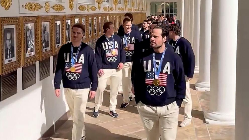 PHOTO: Wearing their gold medals, USA men's Olympic ice hockey players Matthew Tkachuk and Auston Mathews lead their teammates along the colonnade at the White House in Washington, Feb. 24, 2026.