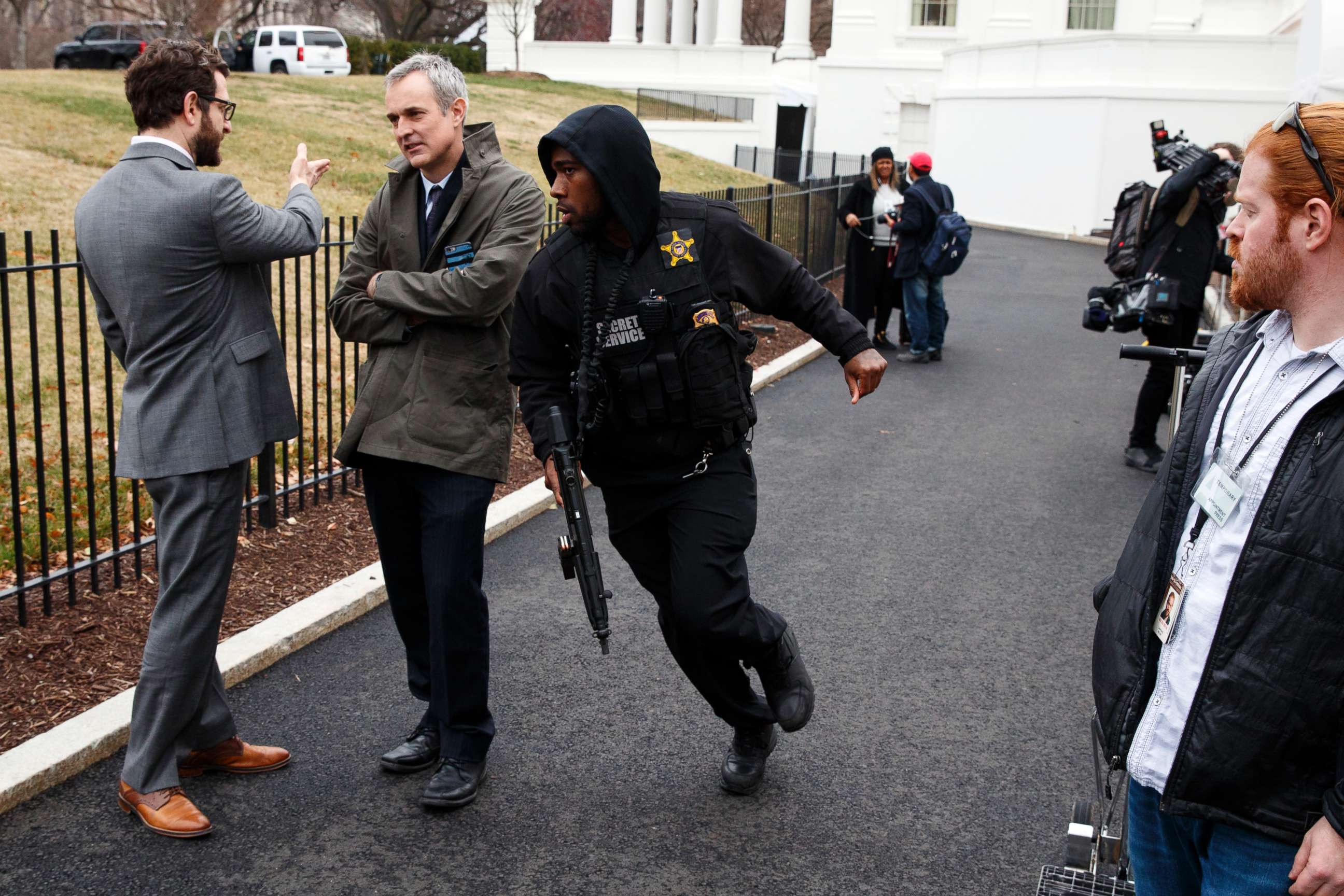 PHOTO: A Secret Service officer rushes past reporters after a vehicle rammed into a security barrier near the White House, Feb. 23, 2018, in Washington.