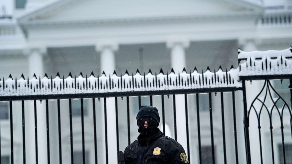  A member of the Secret Service stands guard outside the White House, Jan. 13, 2019, in Washington. 
