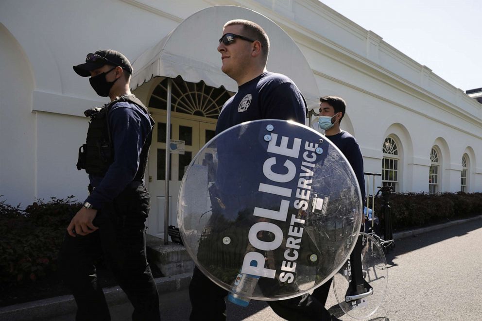 PHOTO: Members of the U.S. Secret Service carry riot shields on a driveway at the White House in Washington, D.C., on April 20, 2021.