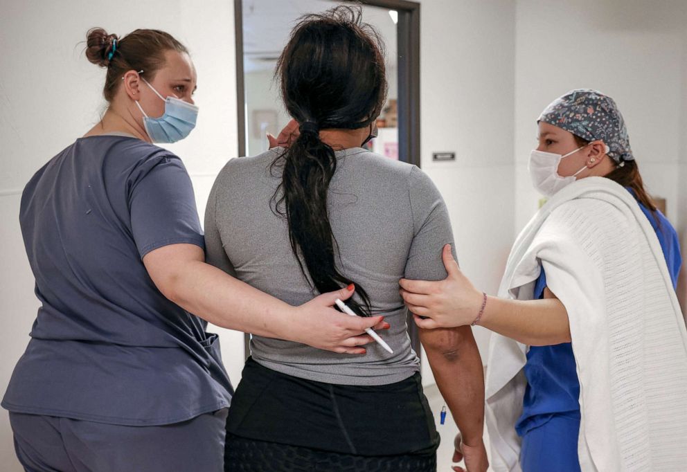 PHOTO: Surgical tech Carissa and recovery room staff member Elise, walk a patient from Texas to the recovery room following her abortion at the Trust Women clinic in Oklahoma City, Dec. 6, 2021.