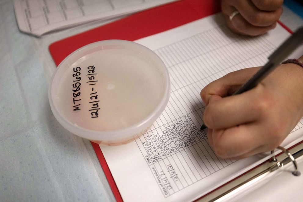 PHOTO: Surgical tech Carissa labels plastic containers holding the "product of conception" which according to Oklahoma law must be stored for thirty days, at the Trust Women clinic in Oklahoma City, Dec. 6, 2021.