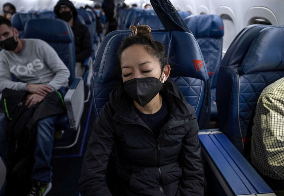 PHOTO: Dr. Shelly Tien, 40, sleeps on her flight from Birmingham, Alabama to Atlanta, Georgia, March 14, 2022.