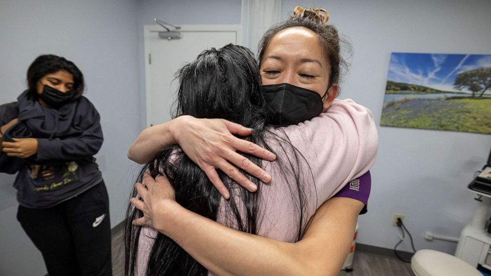 PHOTO: OC, the older sister of pregnant MC, 24, hugs Dr. Shelly Tien, 40, in gratitude, following her sister's appointment at Planned Parenthood in Jacksonville, Florida, March 15, 2022.