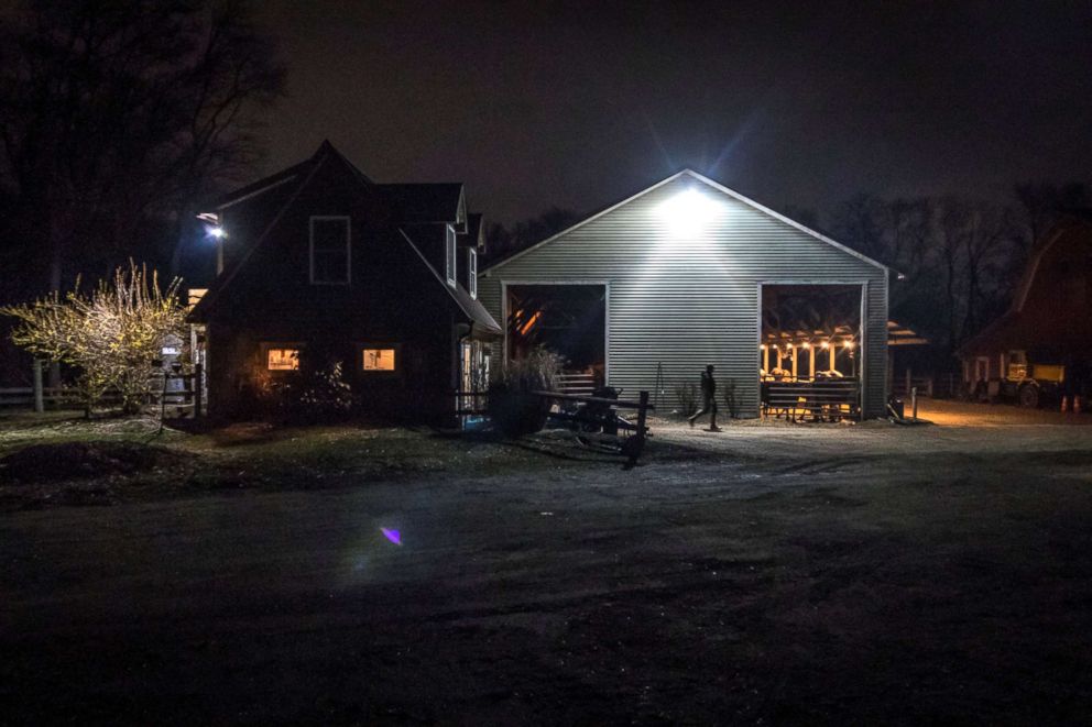 PHOTO: Scooter LaPrise, 53, walks from the milk storage room after the nighttime milking at EMMA Acres dairy farm, in Exeter, Rhode Island, April 12, 2018.