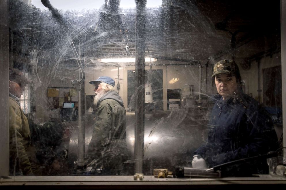 PHOTO: Scooter LaPrise, 53, and Cynthia LaPrise, 52, the owners of EMMA Acres dairy farm, gather in the milk storage room preparing for the truck that picks up the milk to arrive in Exeter, Rhode Island, April 7, 2018.