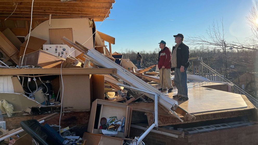 PHOTO: Wilbert Neil, 88, and his son Jerry Neil, 63, look at the remains of Wilbert Neil's home after a tornado struck in Gilbertsville, Ky., Dec. 12, 2021.