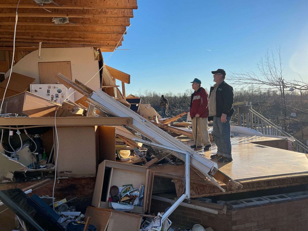 PHOTO: Wilbert Neil, 88, and his son Jerry Neil, 63, look at the remains of Wilbert Neil's home after a tornado struck in Gilbertsville, Ky., Dec. 12, 2021.