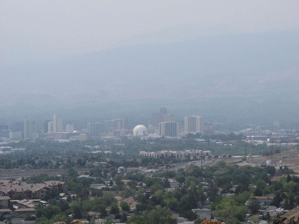 PHOTO: Smoke from wildfires in California blankets downtown Reno, Nev., Aug. 18, 2021, obscuring the Sierra range typically visible to the west. 