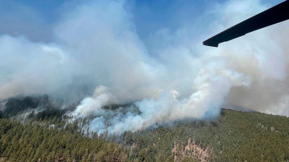 PHOTO: A National Guard Aviation UH-60 Black Hawk flies as part of firefighting efforts, dropping water on the Calf Canyon/Hermits Peak fire in northern New Mexico, May, 1, 2022.