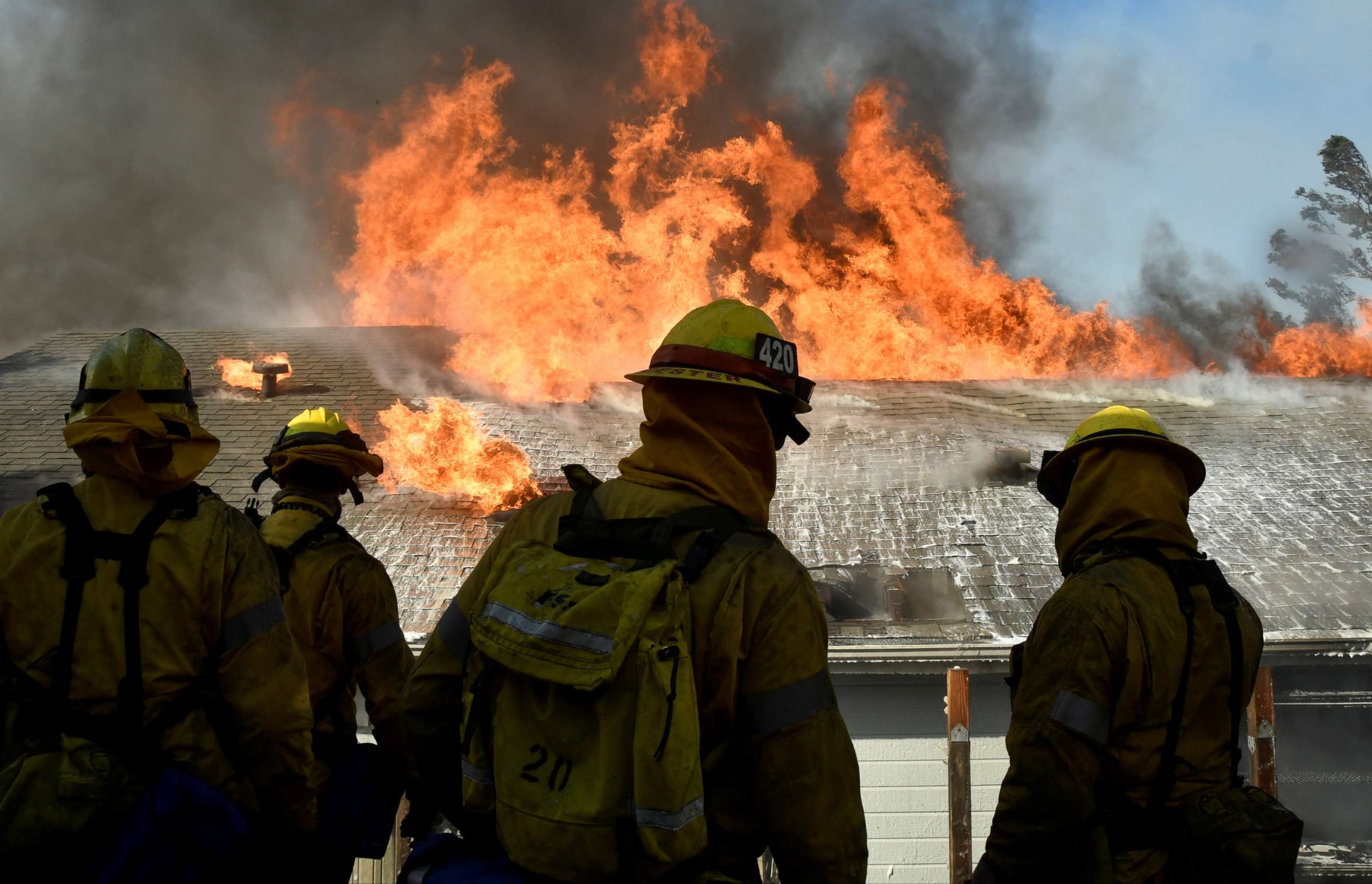 PHOTO: Firefighters battle to save one of many homes from a wildfire in Sylmar, Calif., Dec. 5, 2017.  