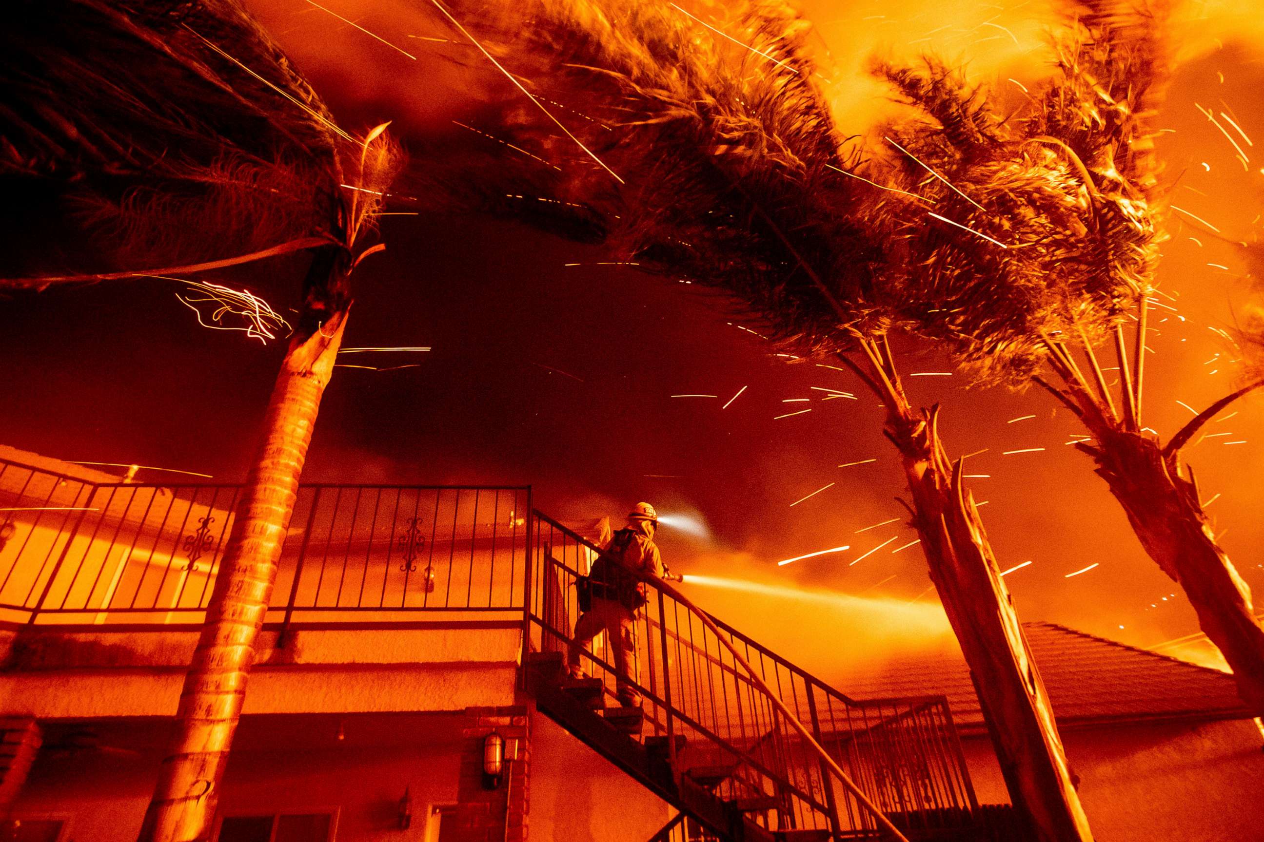 PHOTO: A firefighter sprays water as embers threaten a residence as the Hillside fire burns through San Bernardino, Calif., Oct. 31, 2019. 