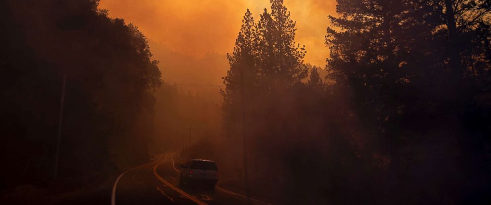 PHOTO: A vehicle drives through smoke from a wildfire near Pulga, Calif., Nov. 11, 2018. 