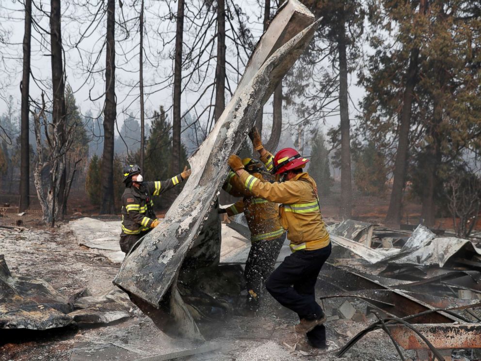 PHOTO: Firefighters move debris while recovering human remains from a trailer home destroyed by the Camp Fire in Paradise, Calif., Nov. 17, 2018. 