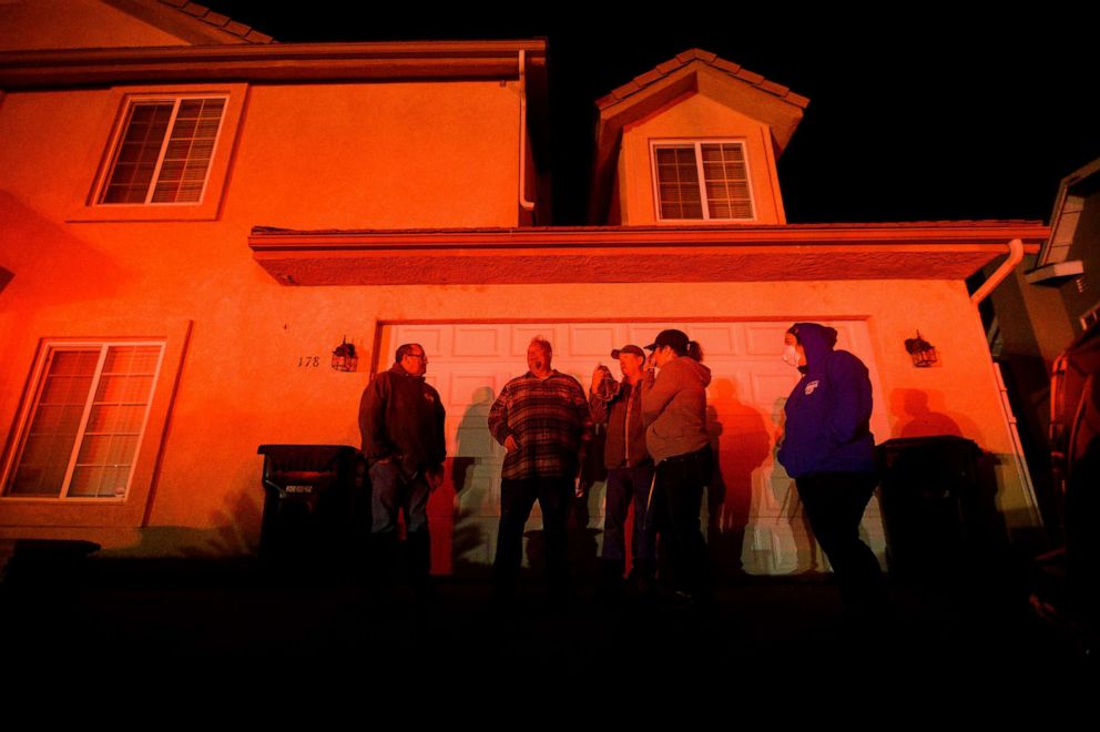 PHOTO: Residents and their friends watch neighboring homes burn as the Hillside fire tears through San Bernardino, Calif., Oct. 31, 2019. 