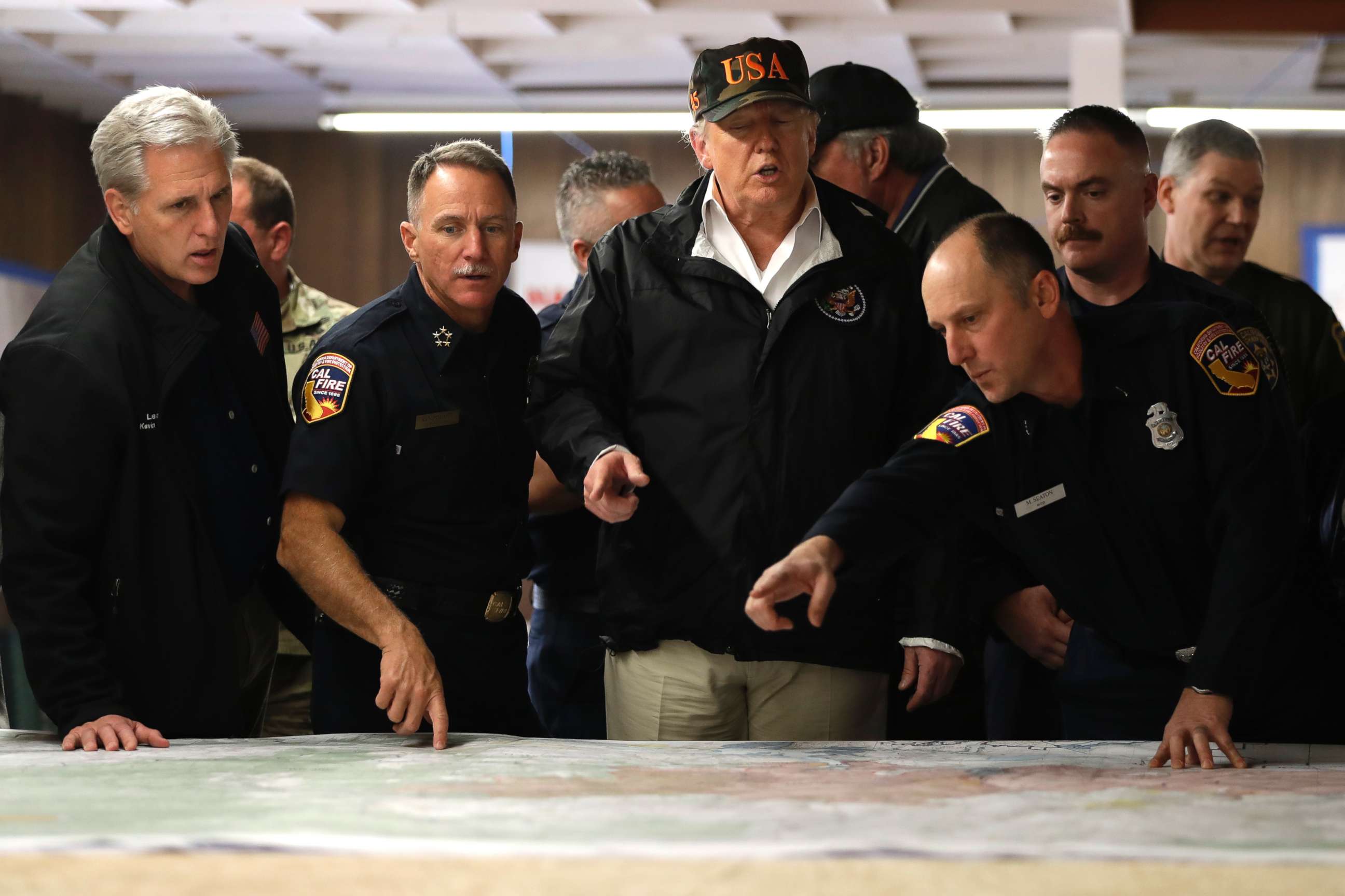 PHOTO: President Donald Trump looks at a map as he visits with first responders and local officials at an operations center responding to the wildfires, Nov. 17, 2018, in Chico, Calif.