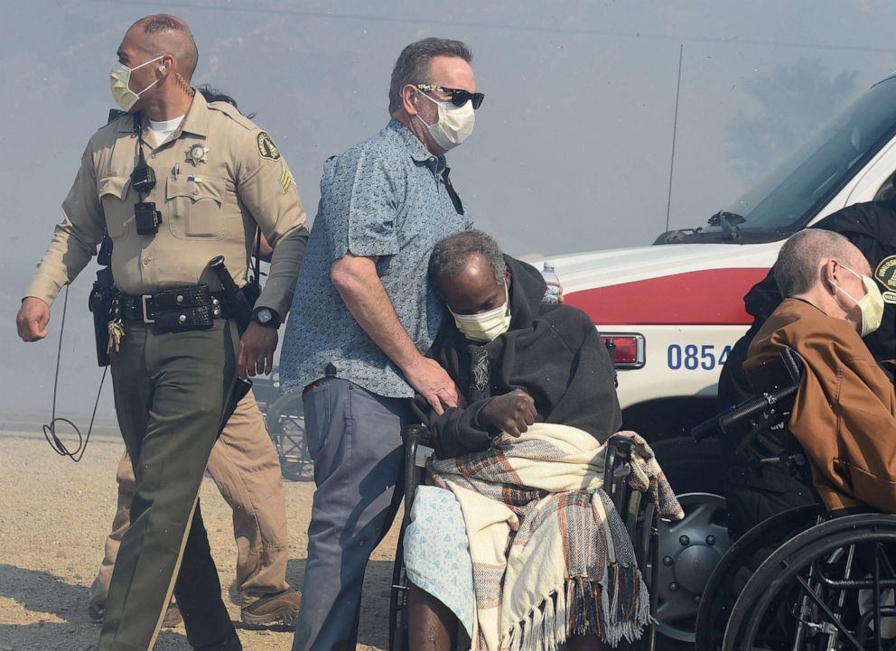 PHOTO: Elderly residents of the Riverside Heights Healthcare Center in Jurupa Valley, Calif. are evacuated from their care facility as flames and smoke from the Hill Fire approach, Oct 30, 2019.