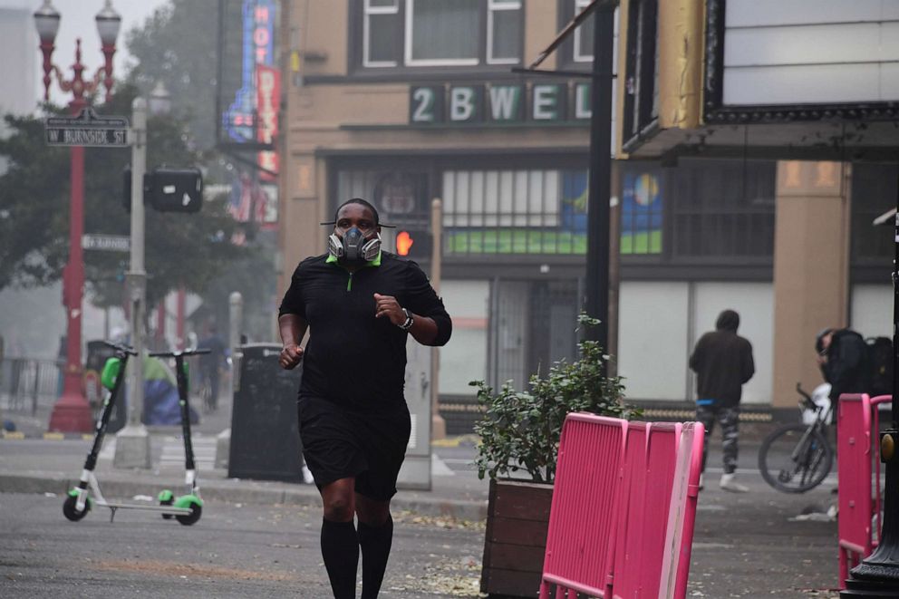 PHOTO: A jogger wears a respirator as he exercises in downtown Portland, Ore. where air quality due to smoke from wildfires was measured to be amongst the worst in the world, Sept. 14, 2020. 