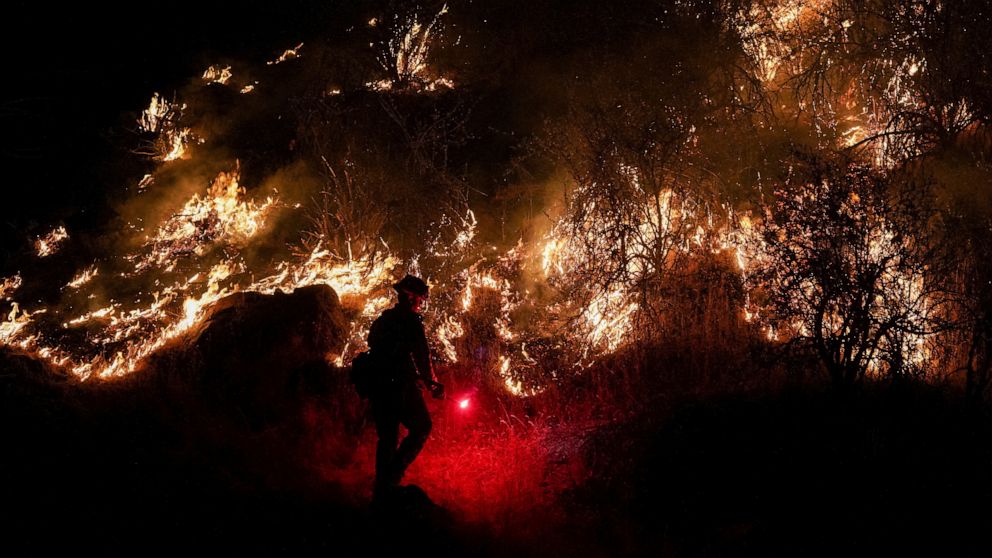 PHOTO: A firefighter works to mitigate the flames as the Oak Fire burns near Mariposa, Calif., July 22, 2022.