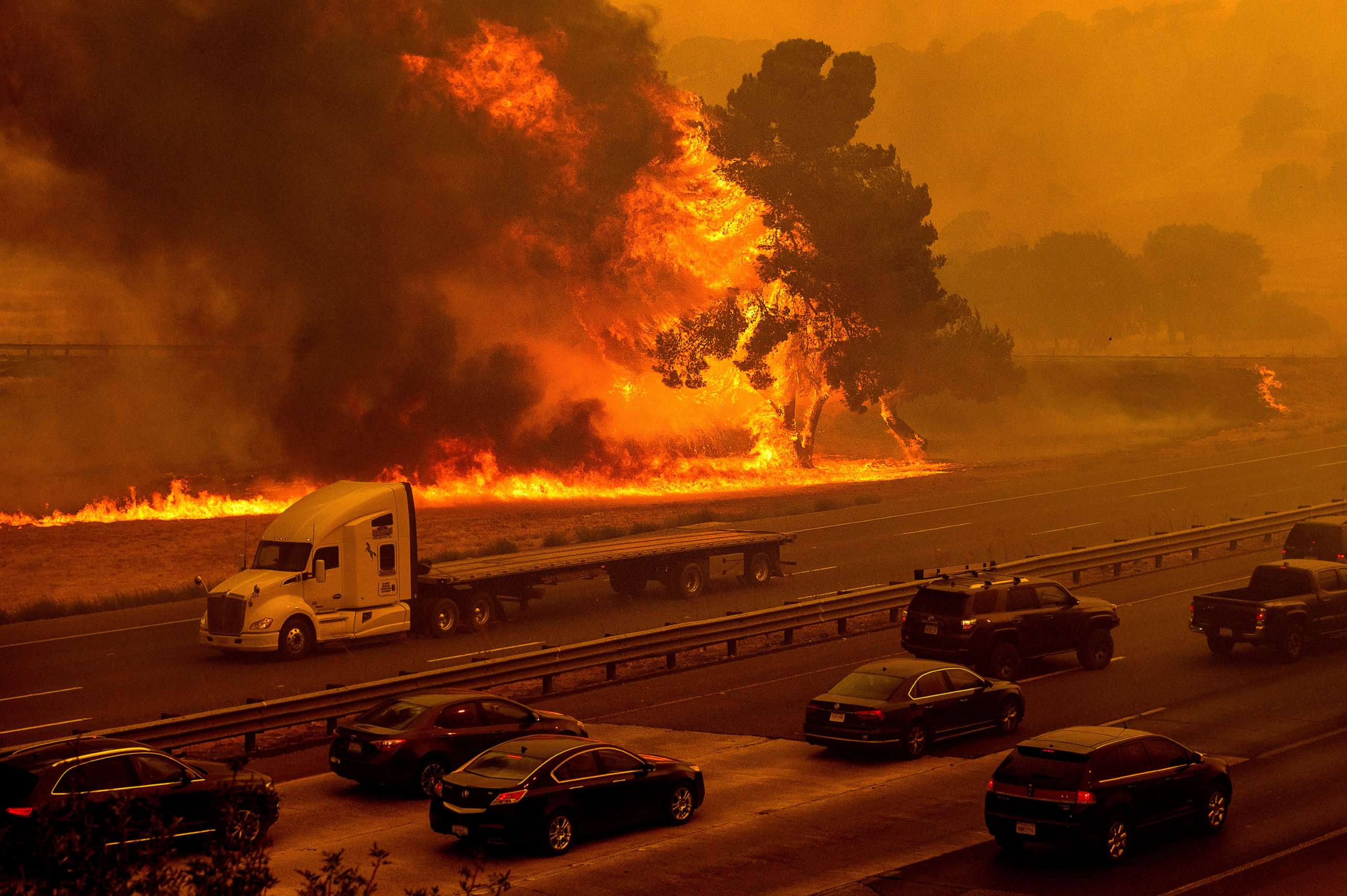 PHOTO: Flames from the LNU Lightning Complex fires jump Interstate 80 in Vacaville, Calif., Aug. 19, 2020.
