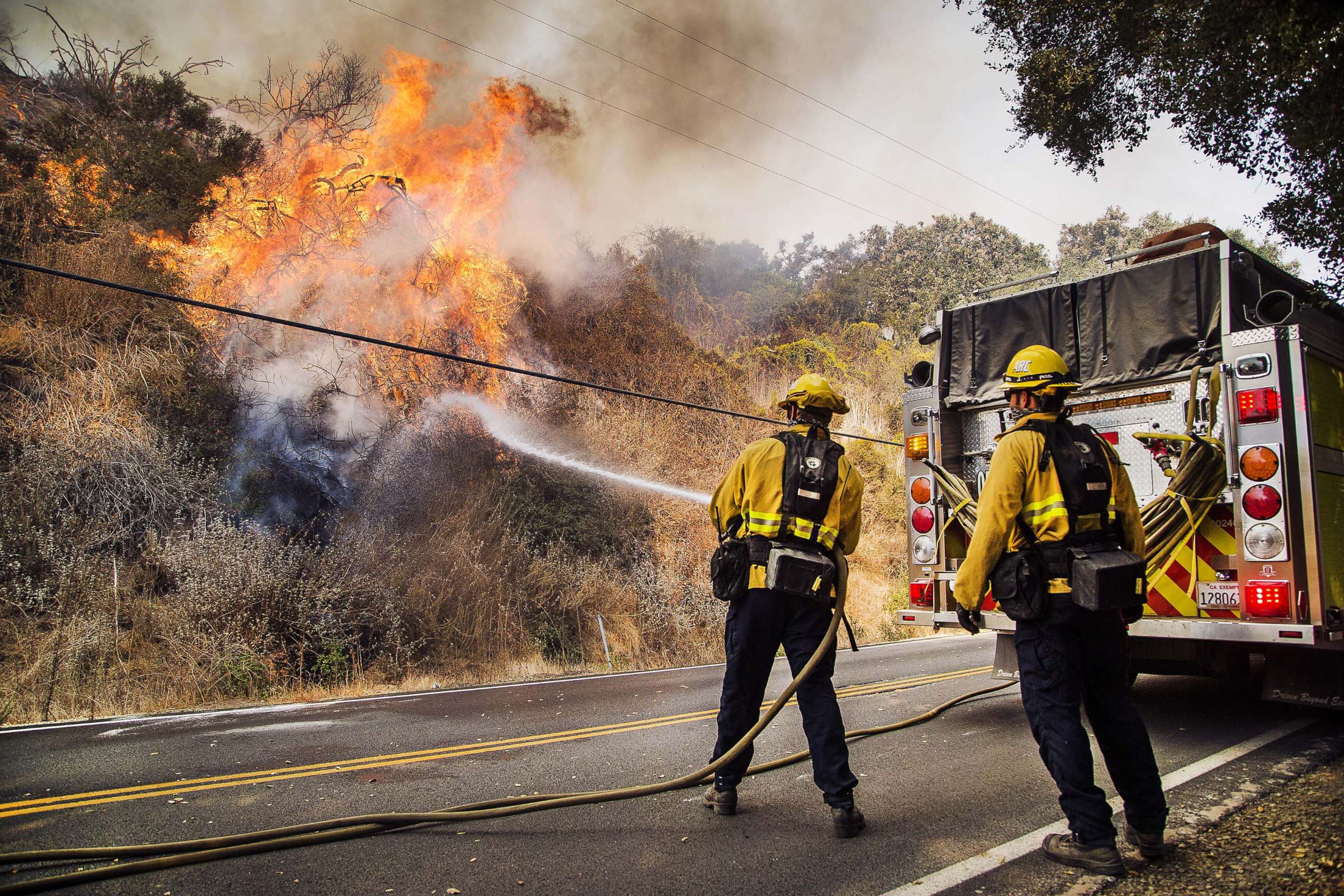 PHOTO: Firefighters battle flames on State Route 150 between Carpinteria and Ojai Calif., Dec. 11, 2017. 
