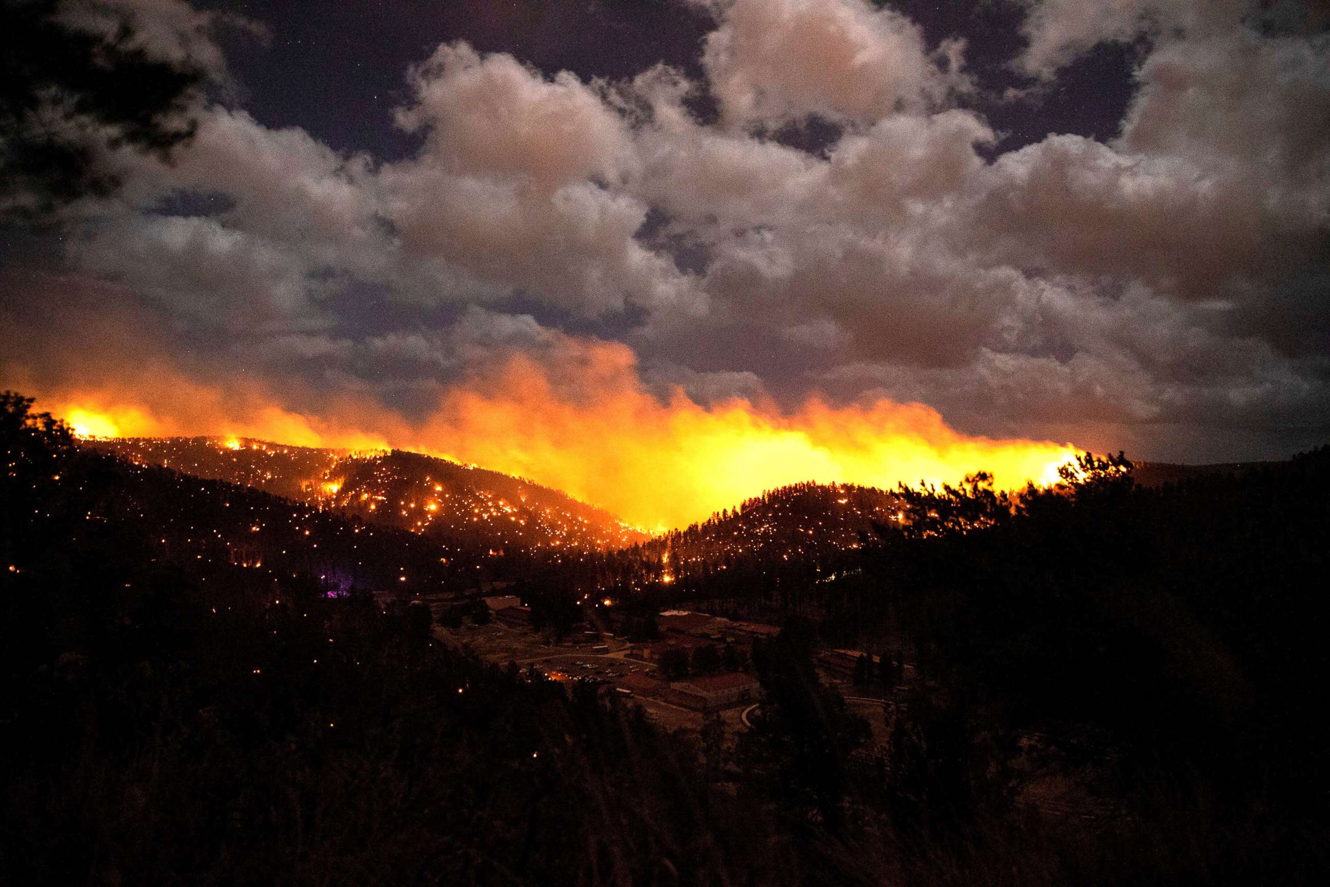 PHOTO: A wildfire burns in the heart of the village in Ruidoso, N.M., April 12, 2022.