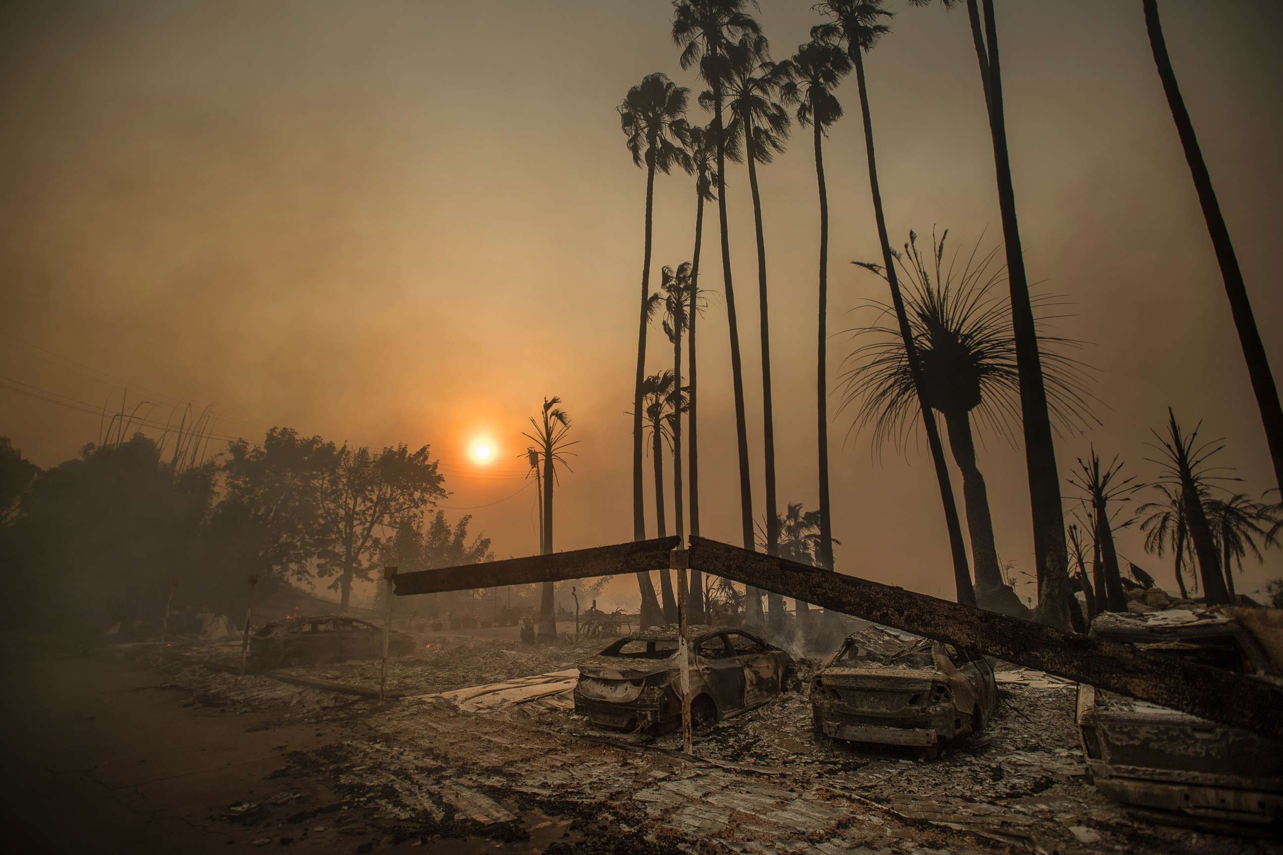 PHOTO: Smoke rises behind a leveled apartment complex as a wildfire burns in Ventura, Calif., Dec. 5, 2017