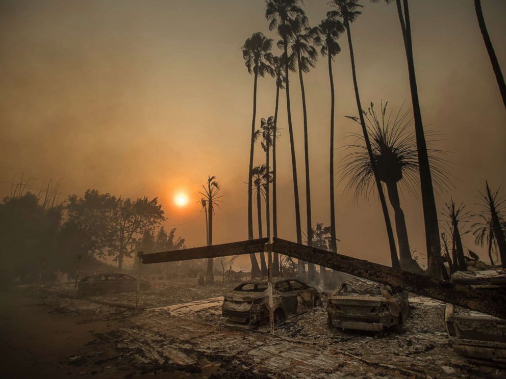 PHOTO: Smoke rises behind a leveled apartment complex as a wildfire burns in Ventura, Calif., Dec. 5, 2017