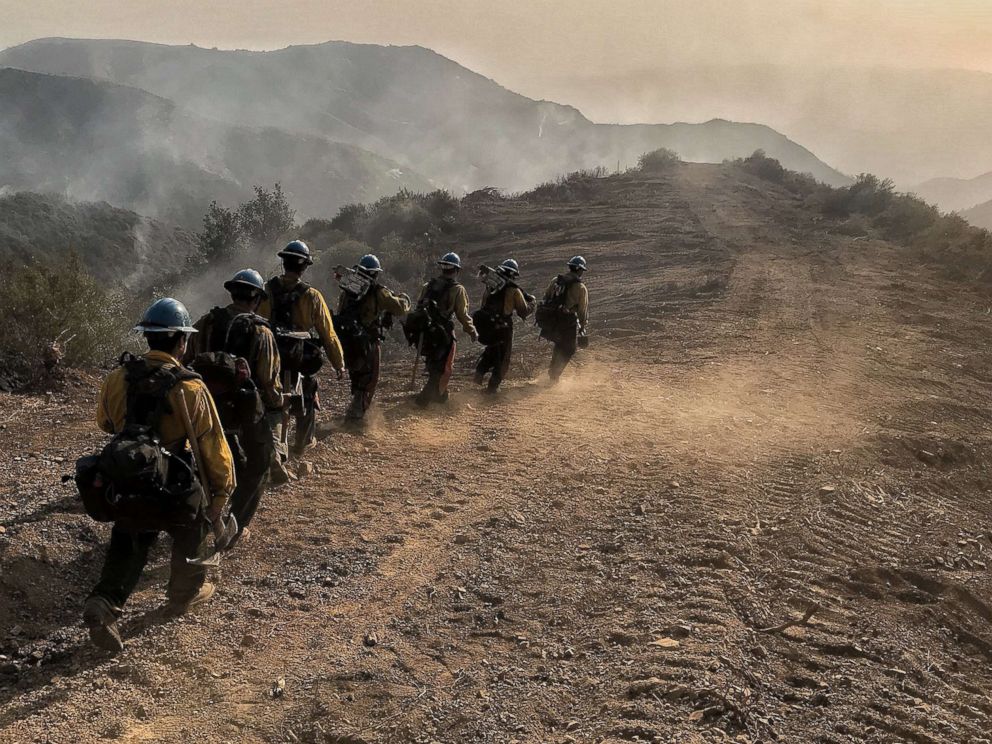 PHOTO: A handout photo made available by the Santa Barbara County Fire Department shows a U.S. Forest Service Hot Shot Crew from Ojai head down a fire break to work off East Camino Cielo near Santa Barbara, Calif., Dec. 17, 2017.