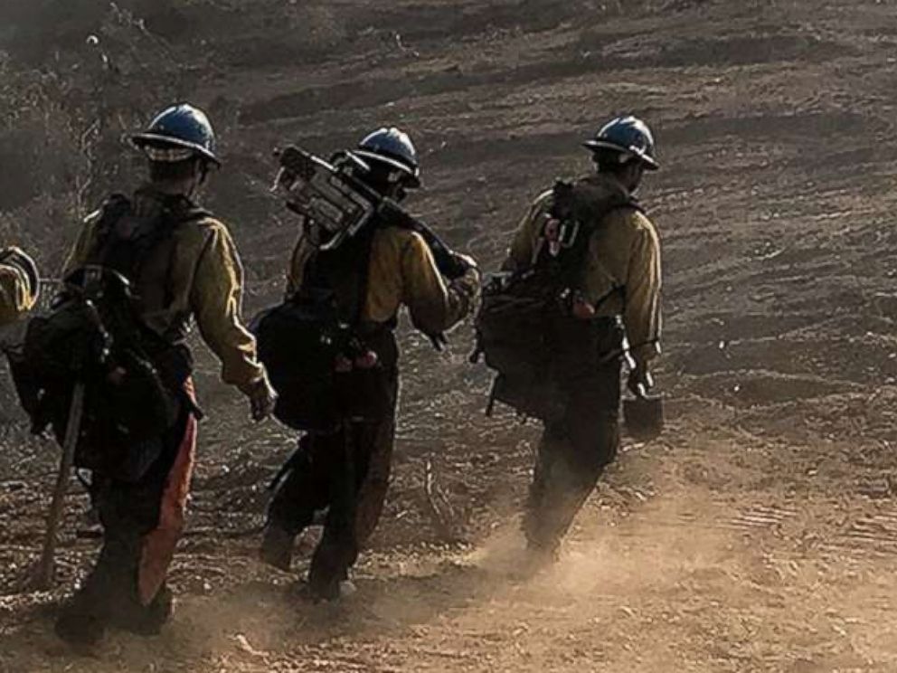 PHOTO: A handout photo made available by the Santa Barbara County Fire Department shows a U.S. Forest Service Hot Shot Crew from Ojai head down a fire break to work off East Camino Cielo near Santa Barbara, Calif., Dec. 17, 2017.