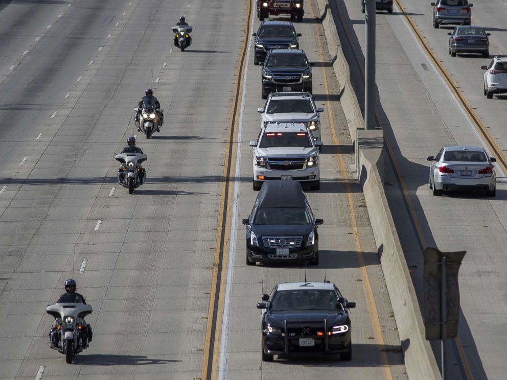 PHOTO: A procession carries the body of Cory Iverson, 32, a fire engineer for Cal Fire San Diego who died fighting the Thomas Fire, from Ventura to San Diego, Dec. 17, 2017, in Pasadena, Calif.