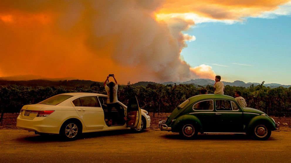 PHOTO: People watch the Walbridge fire, part of the larger LNU Lightning Complex fire, from a vineyard in Healdsburg, Calif. on Aug. 20, 2020.