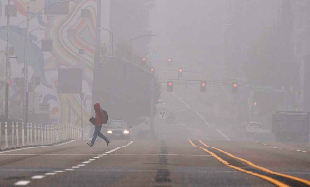 PHOTO: A pedestrian crosses a street in downtown Portland, Ore. where air quality due to smoke from wildfires was measured to be amongst the worst in the world, Sept. 14, 2020.