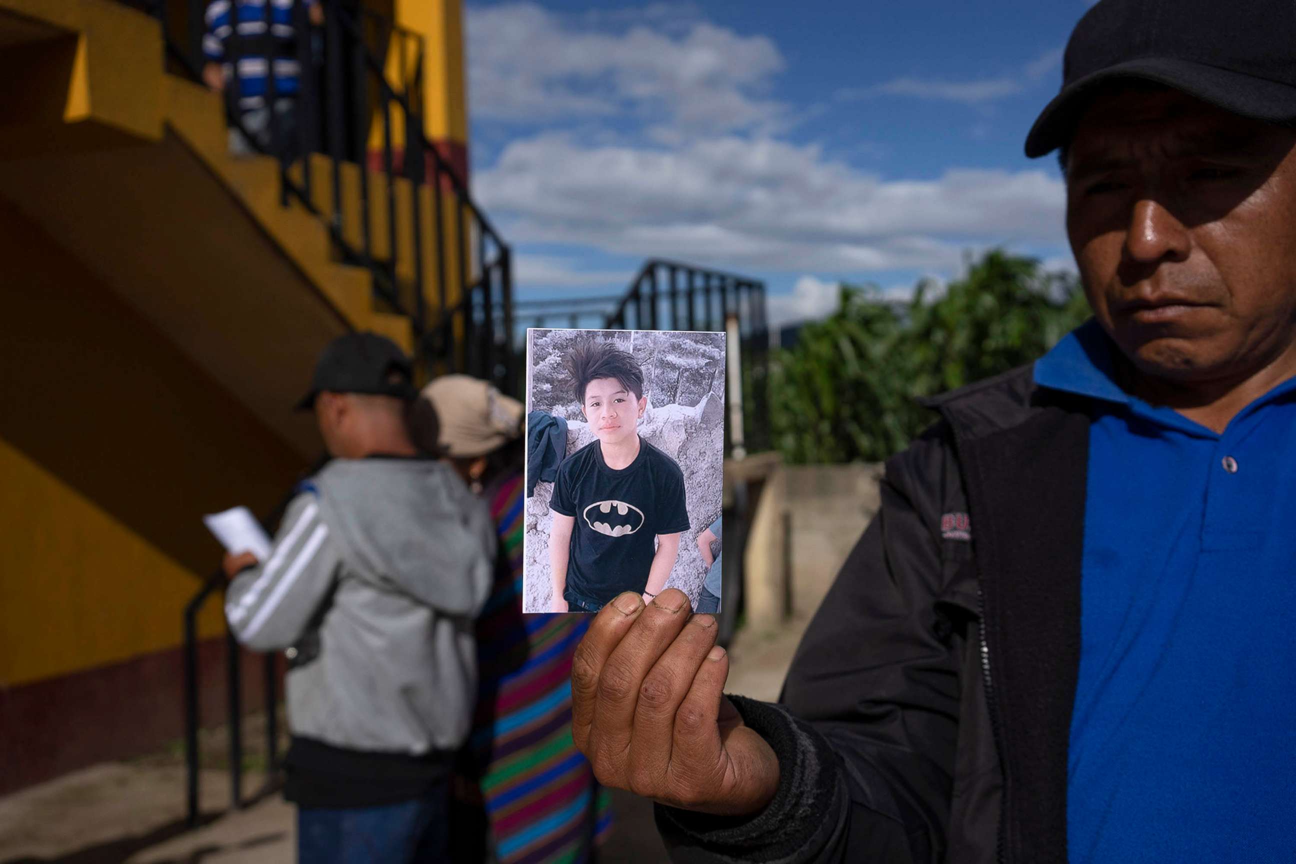 PHOTO: A man holds a portrait of Wilmer Tulul, in Tzucubal, Guatemala, June 29, 2022. 