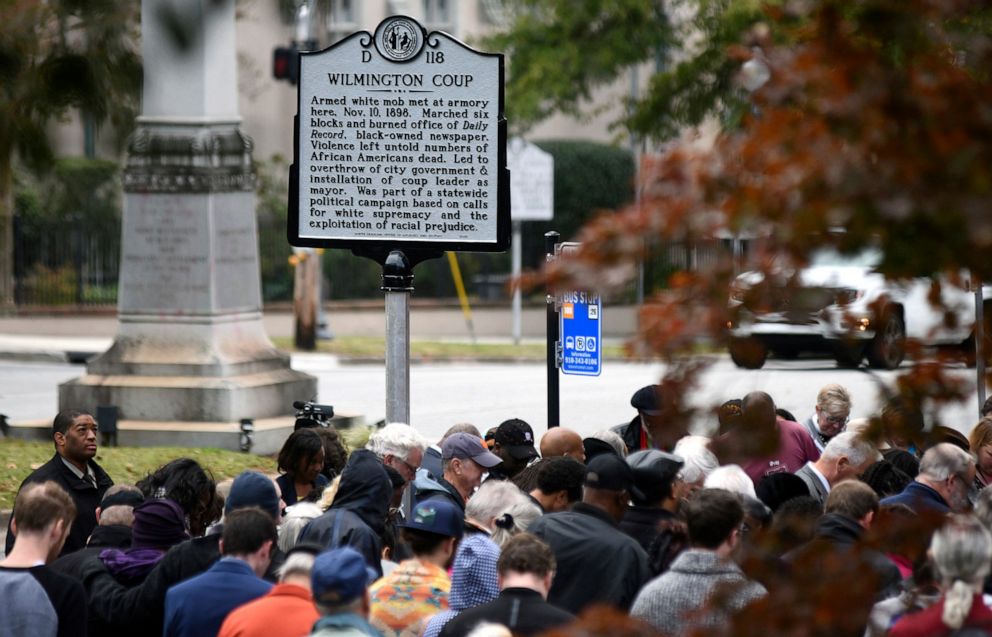 PHOTO: In this Nov. 8, 2019, file photo, people stand under the new North Carolina highway historical marker to the 1898 Wilmington Coup during a dedication ceremony in Wilmington, N.C.