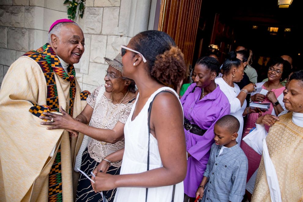 PHOTO: Washington D.C. Archbishop Wilton Gregory, left, greets parishioners following Mass at St. Augustine Church in Washington, June 2, 2019.