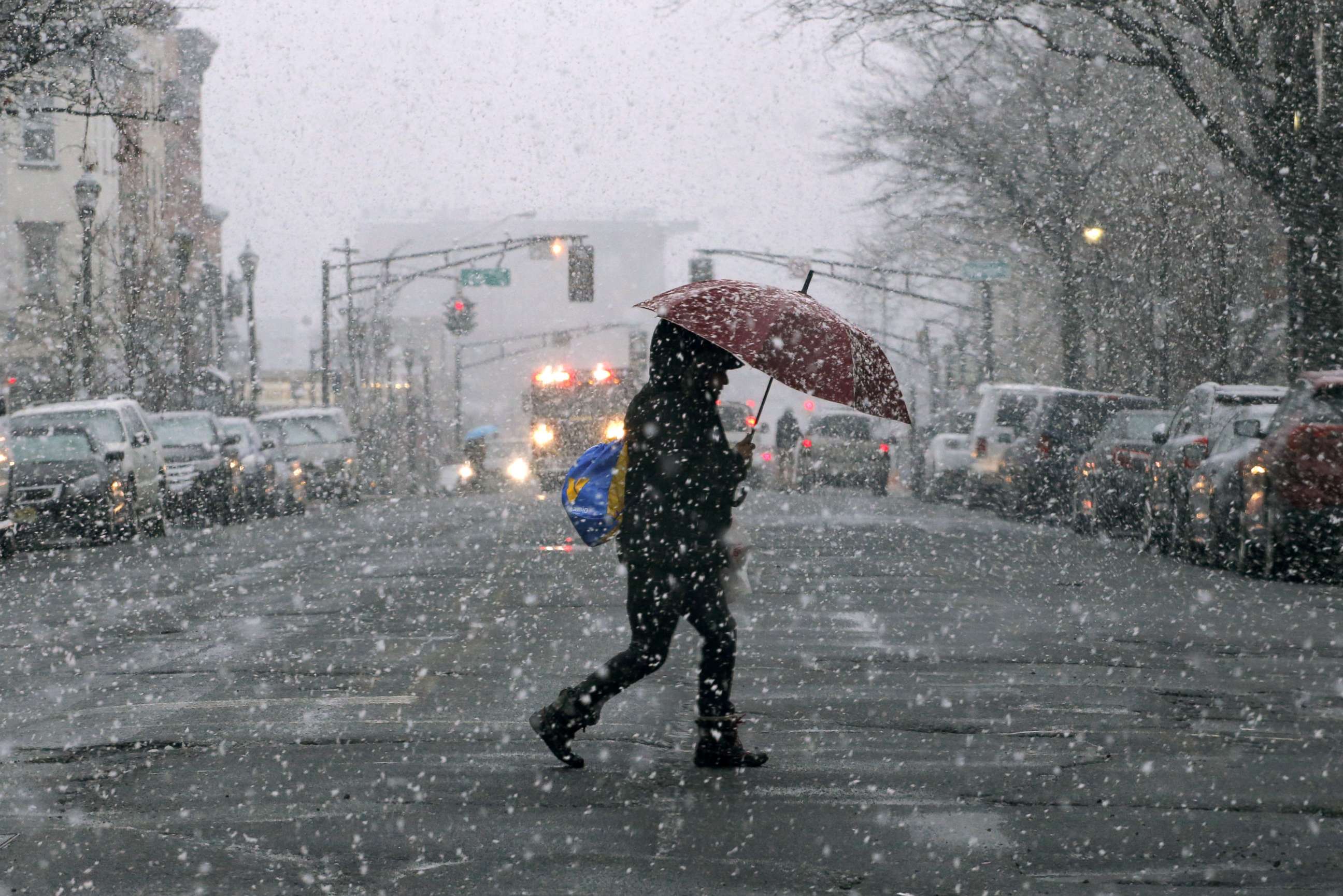 PHOTO: A woman holds an umbrella as snow falls on March 7, 2018 in Hoboken, N.J.