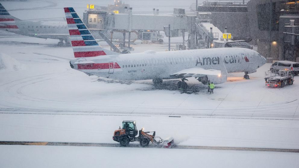 PHOTO: A snow removal machine is seen working on the tarmac of LaGuardia airport in New York, January 25, 2026. 